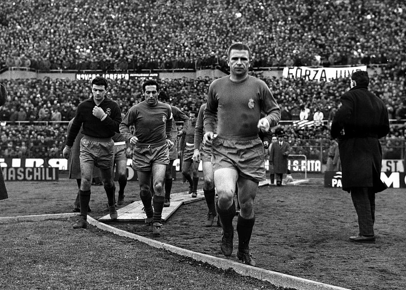 Ferenc Puskas walking onto a football pitch